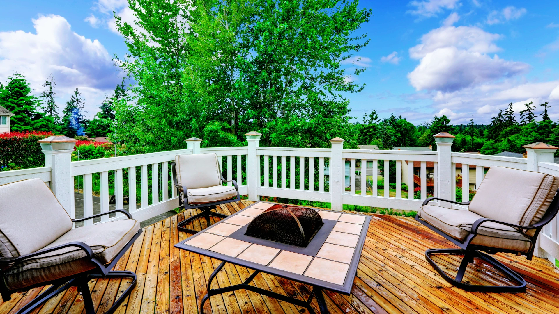 a photo of a deck with a firepit and several chairs